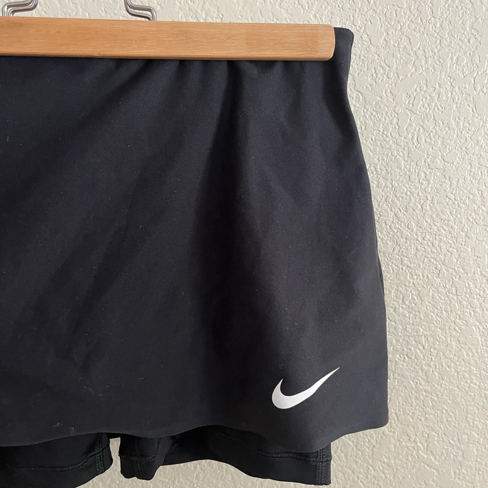 Nike black tennis skirt with shorts liner. Size medium in girls.